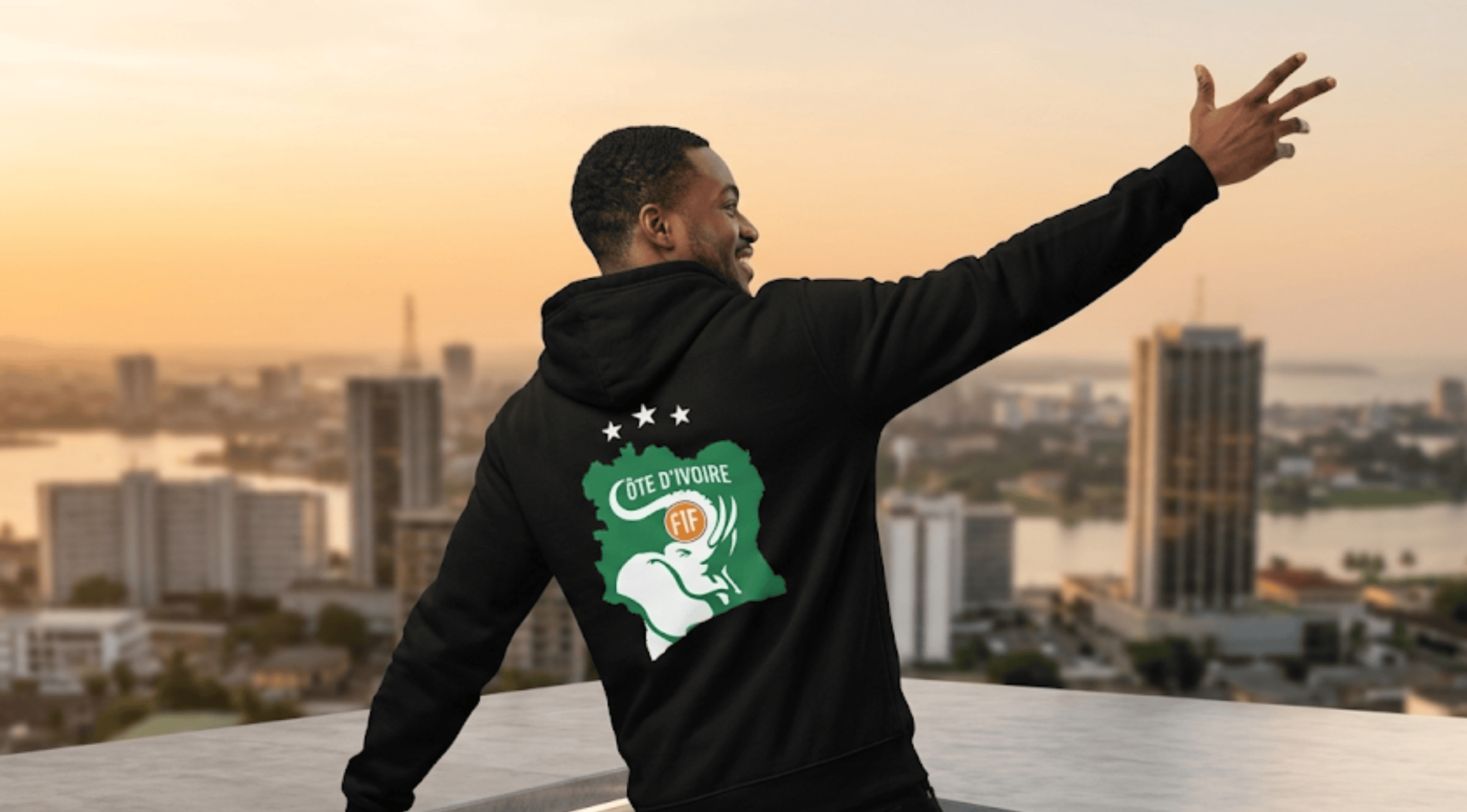 Back view of the FIFA World Cup Côte d’Ivoire black pullover hoodie featuring the green map graphic, white elephant crest, and three white stars.